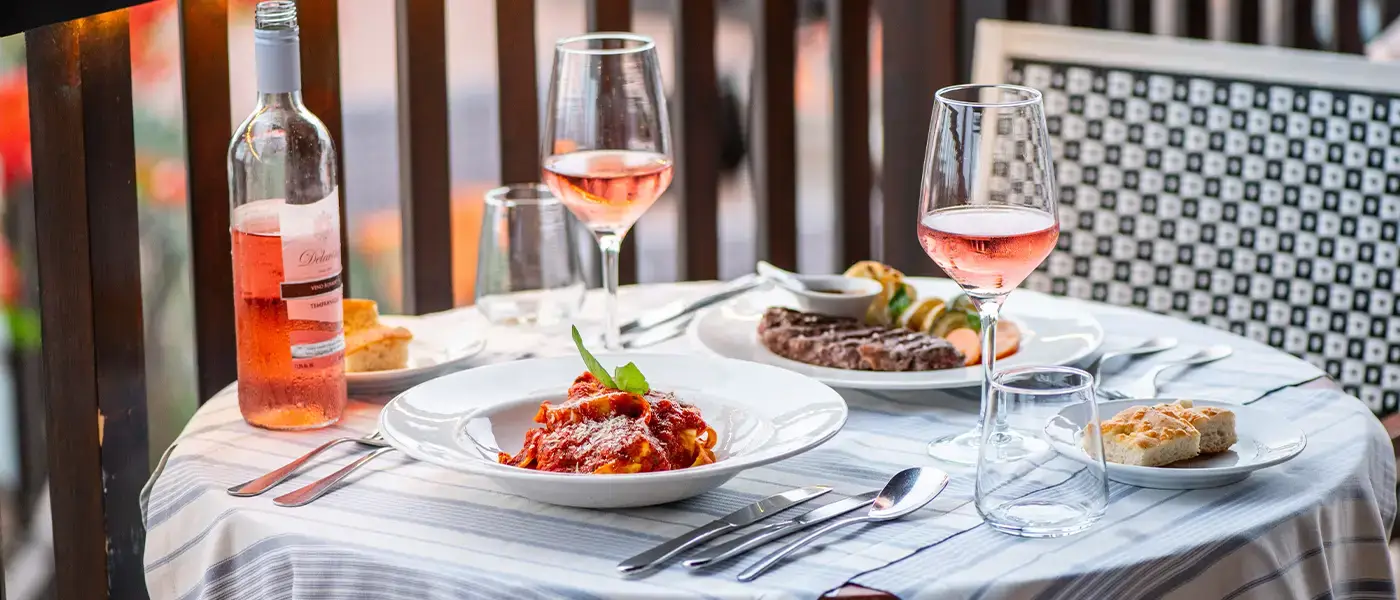 Rosé wine and food served at a table